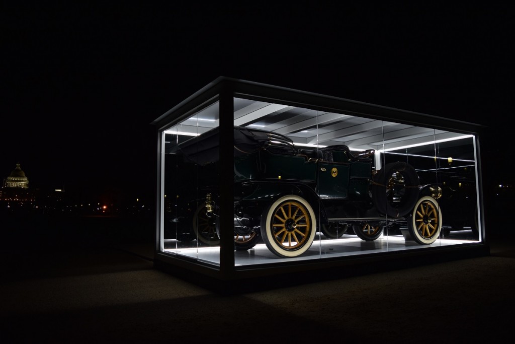 The car in its lit 'jewel box" on display on National Mall at night.